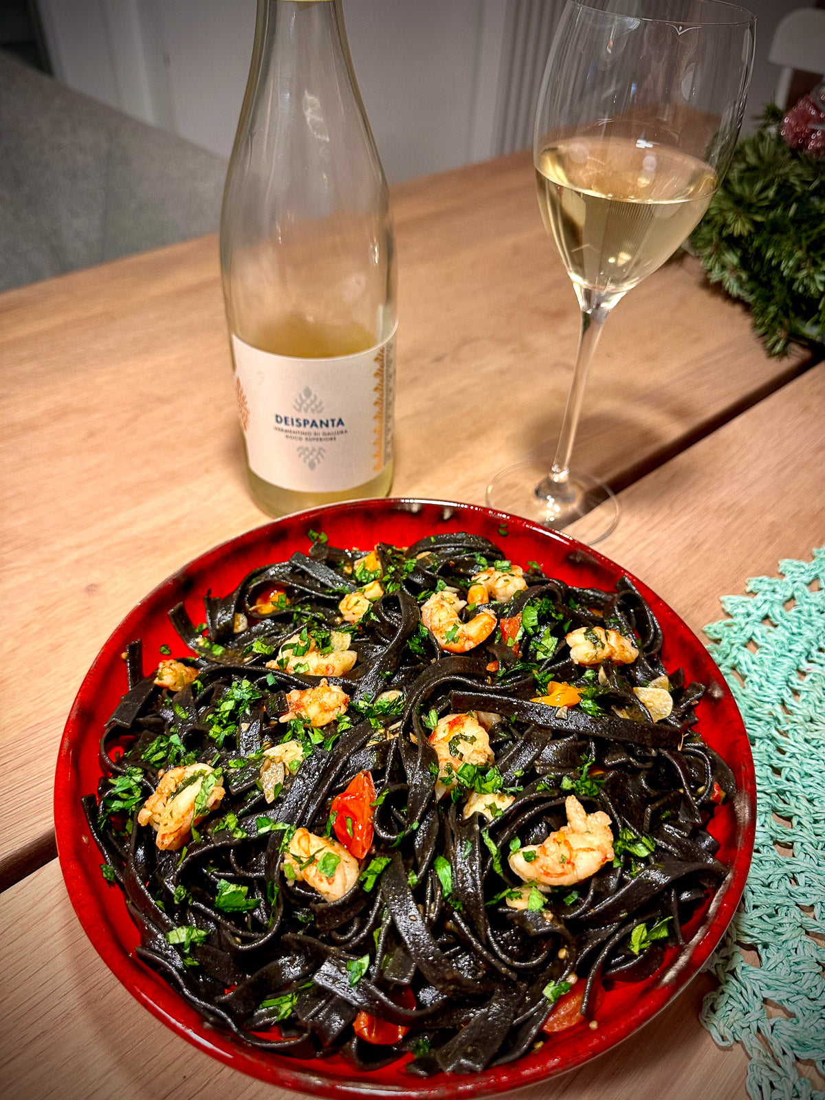 Tagliatelle nero di sepia with seafood and a bottle of white wine