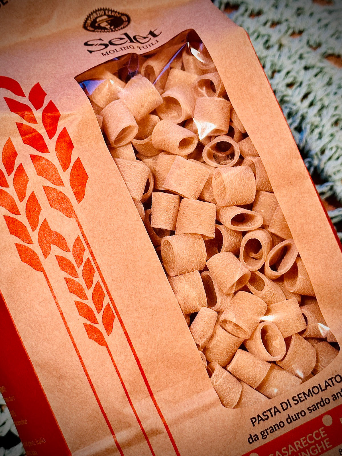 Pack of maccheroni pasta on a blue background