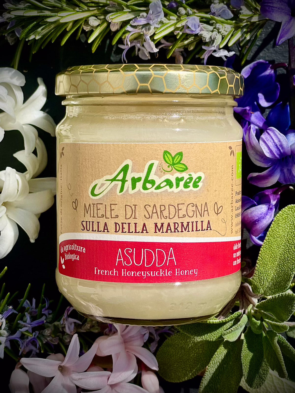 Glas Sulla-Honig mit floralem Hintergrund