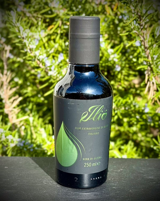 Bottle of olive oil with a green label against a natural background