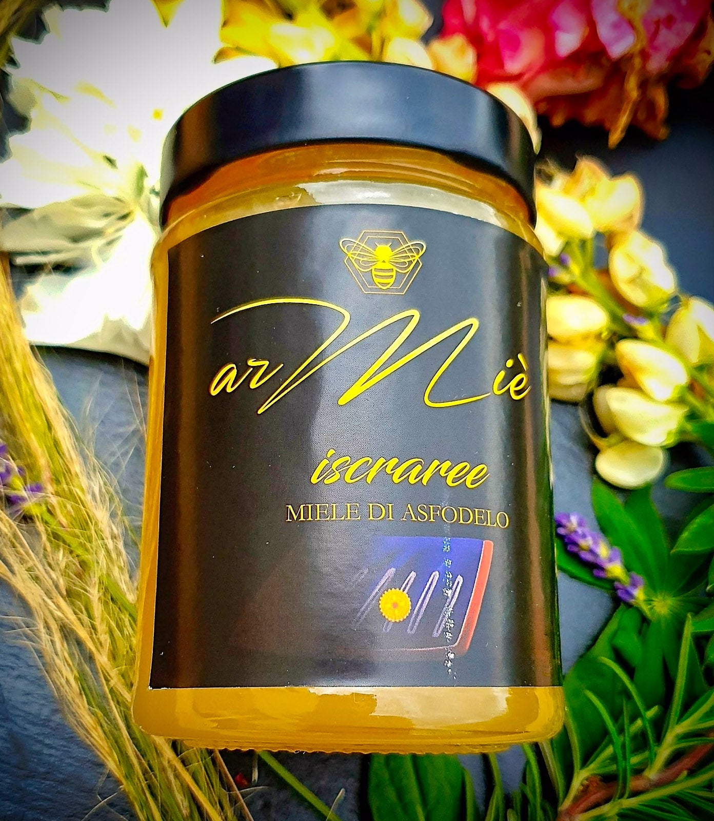 Jar of honey with a black lid and decorative background