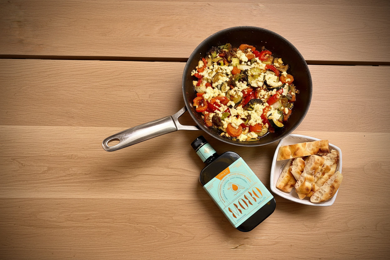 Pan of veggies with flat bread and a bottle of Peranzana Olive oil