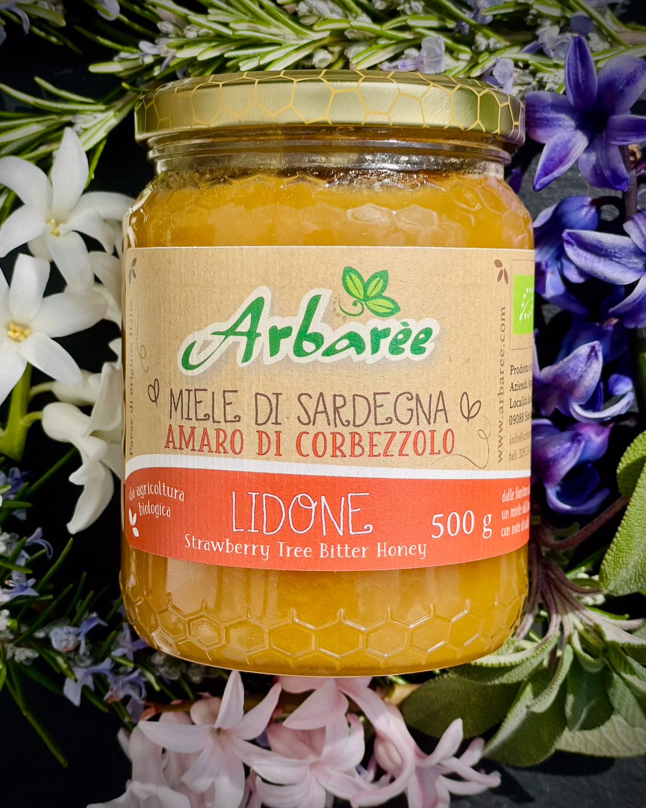 Glas Arbaree-Korbblütenhonig (Erdbeerbaumhonig) mit floralem Hintergrund