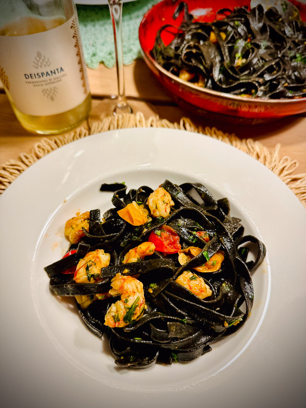 Tagliatelle nero di sepia with seafood and a bottle of white wine
