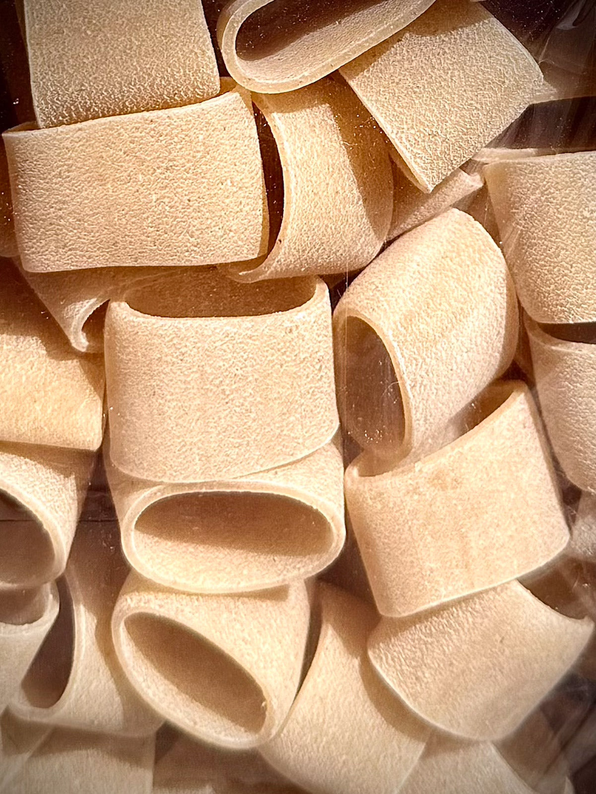 Close-up of uncooked calamarata pasta