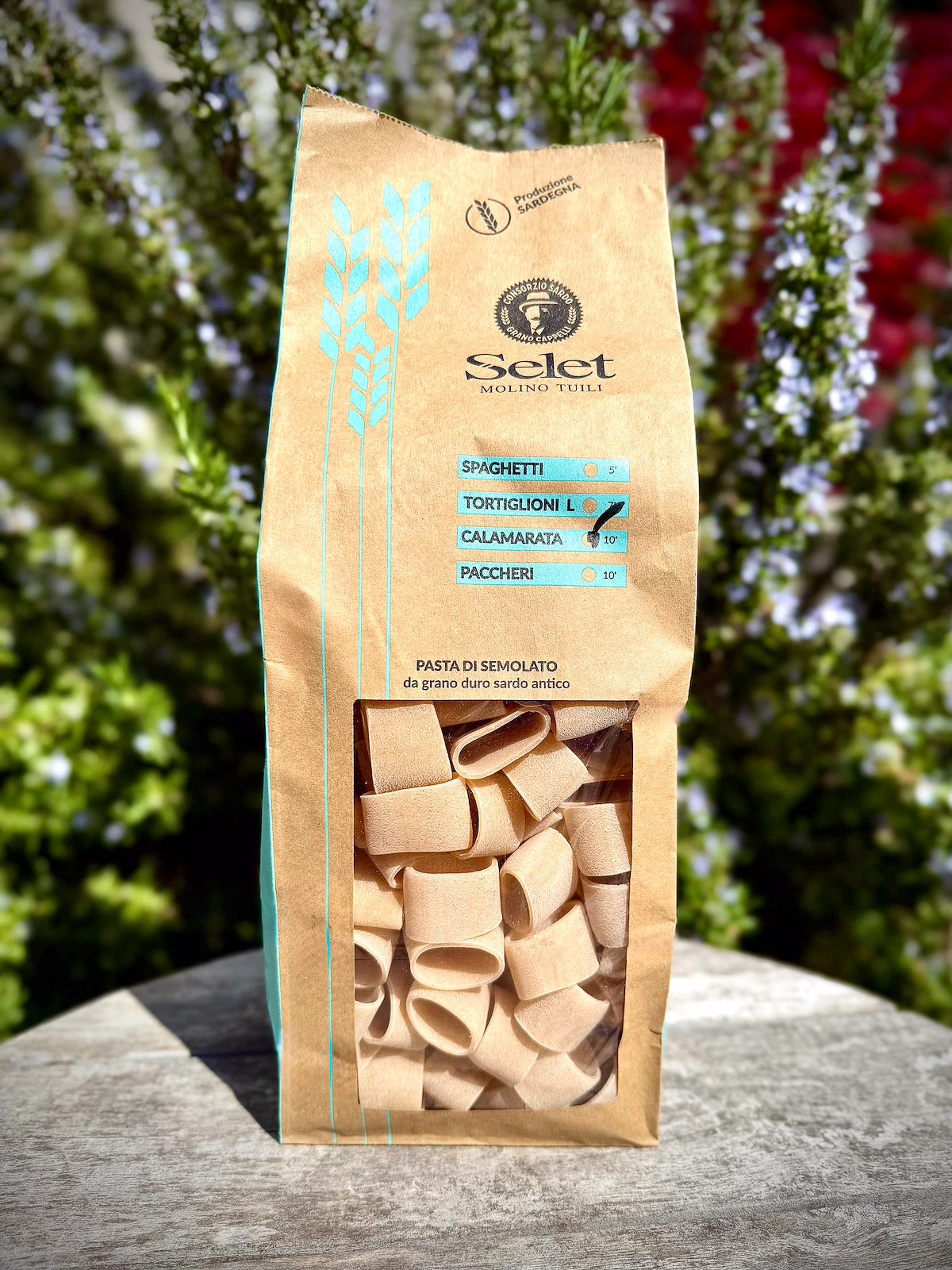 Pasta package with 'Selet' branding on a wooden surface with a blurred natural background