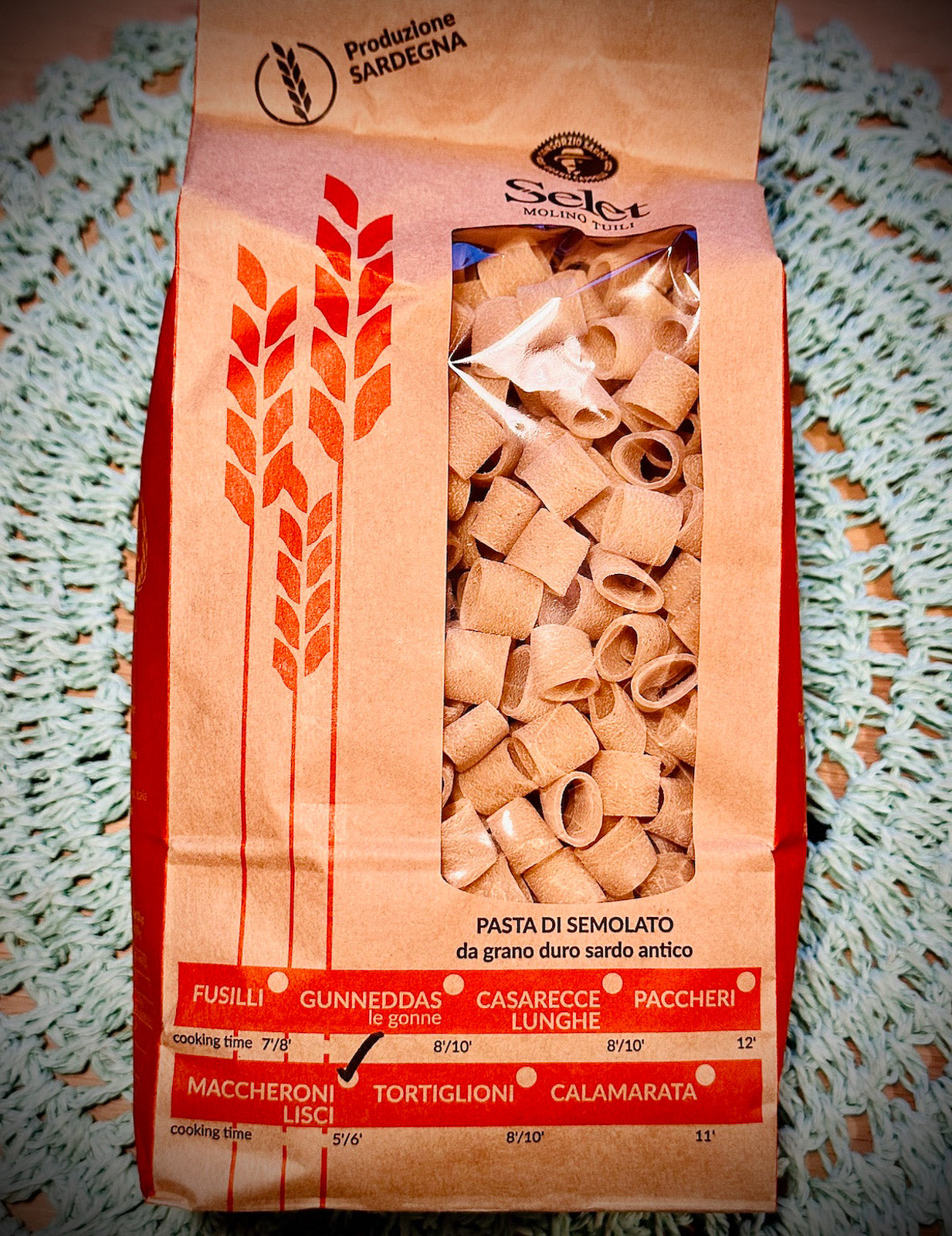 Pack of maccheroni pasta on a blue background