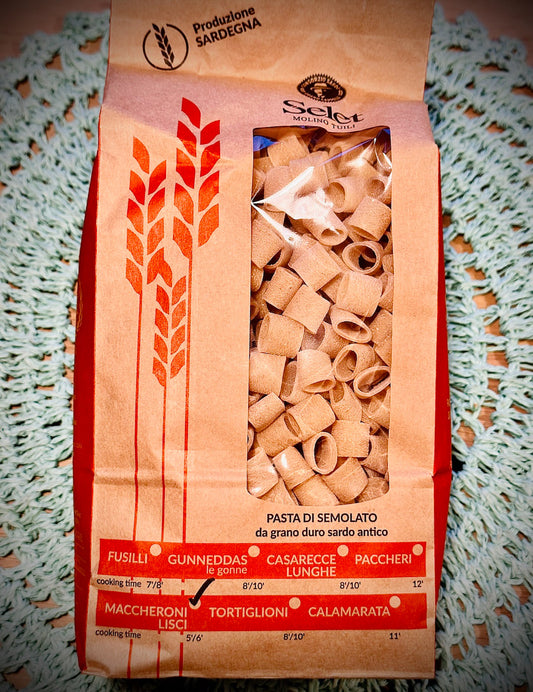 Pack of maccheroni pasta on a blue background