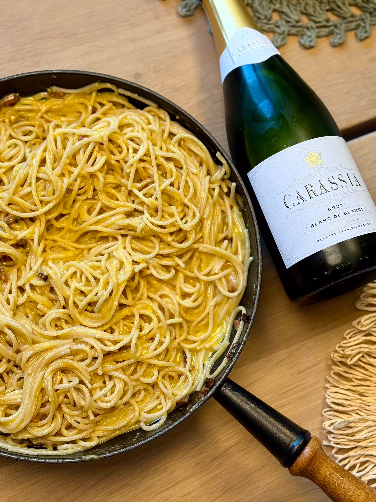 Spaghetti Carbonara with a bottle of sparkling wine blanc de blancs