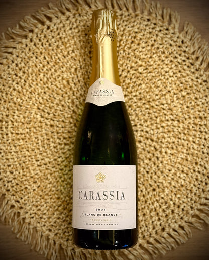 Bottle of Carassia blanc de blancs sparkling on a textured woven surface