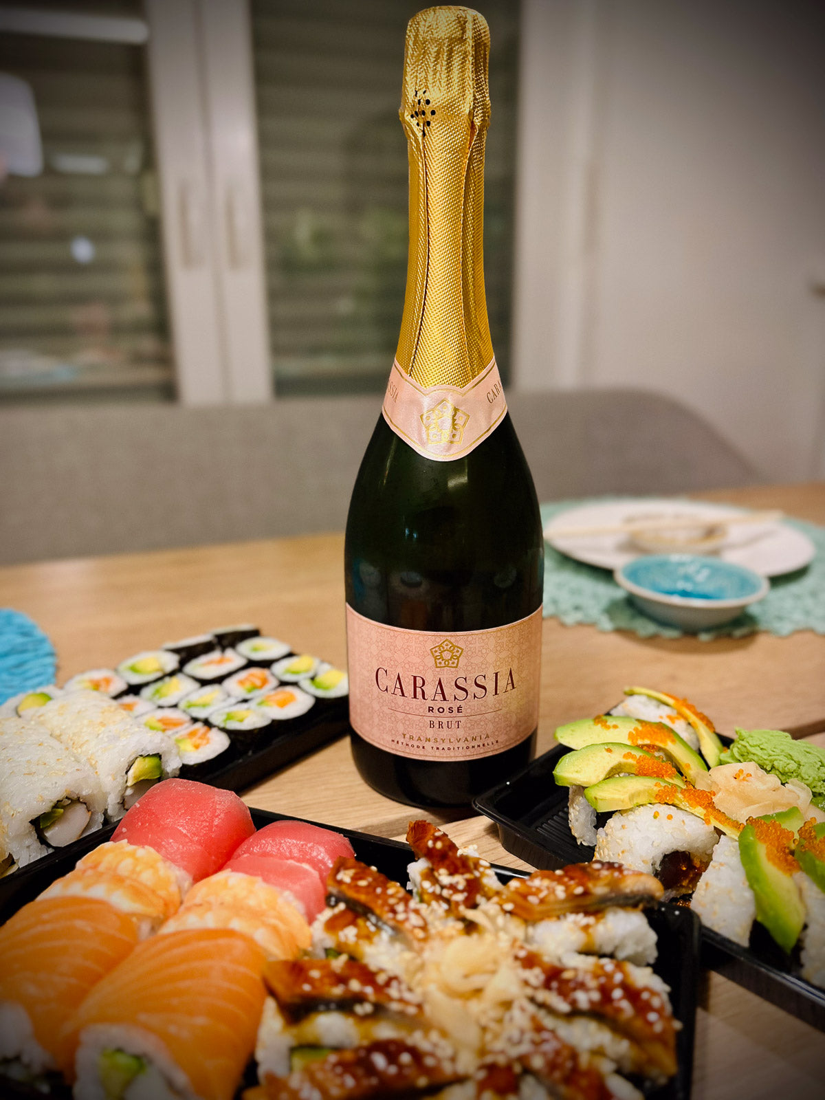 Bottle of Carassia sparkling wine  with a sushi platter on a table